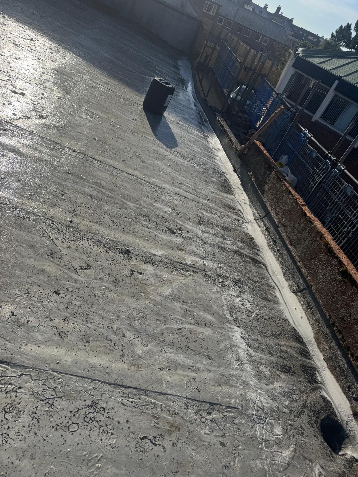 Flat roof after professional cleaning showing clear drainage
