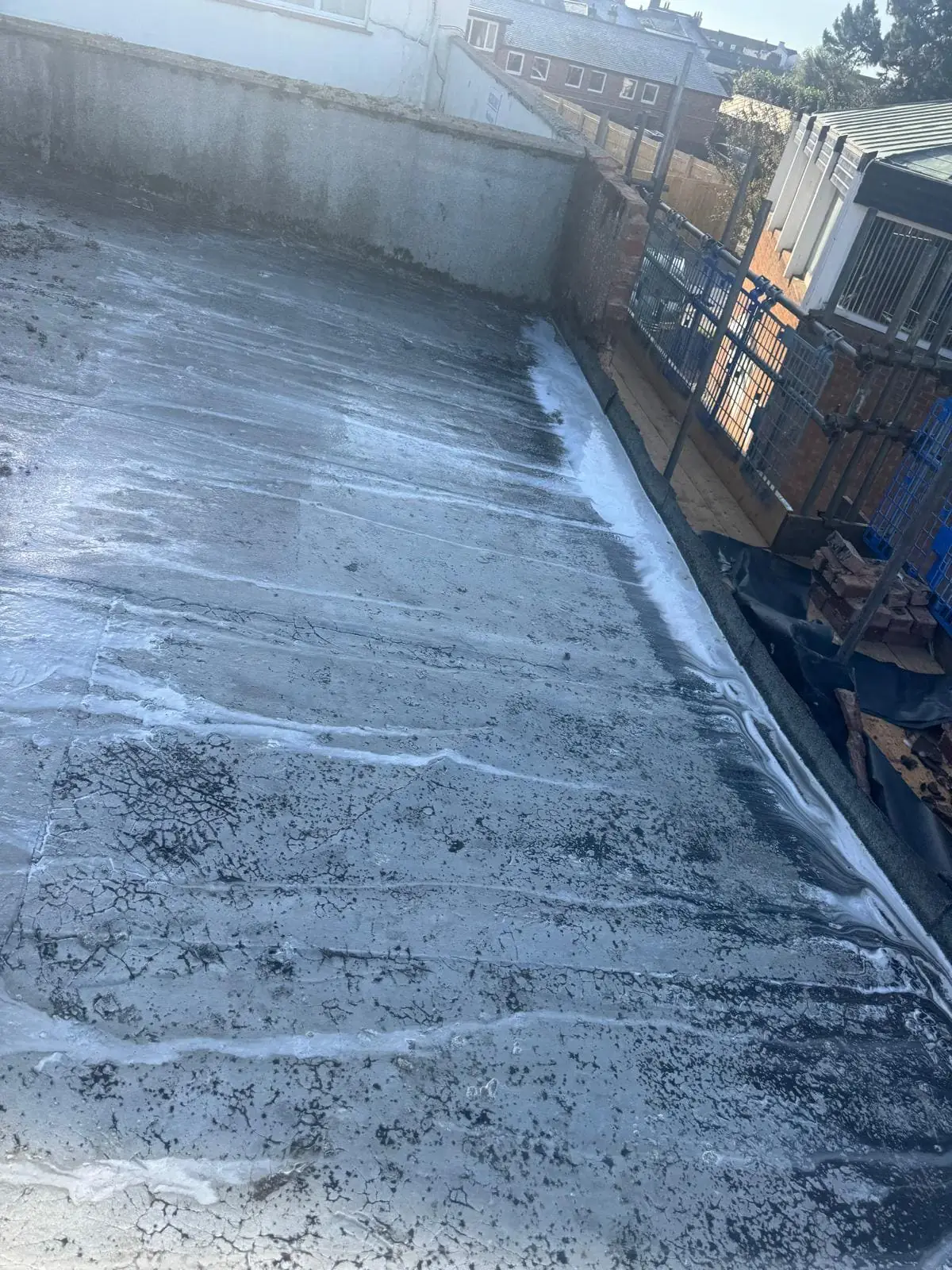 Flat roof surface cleaned of debris and algae