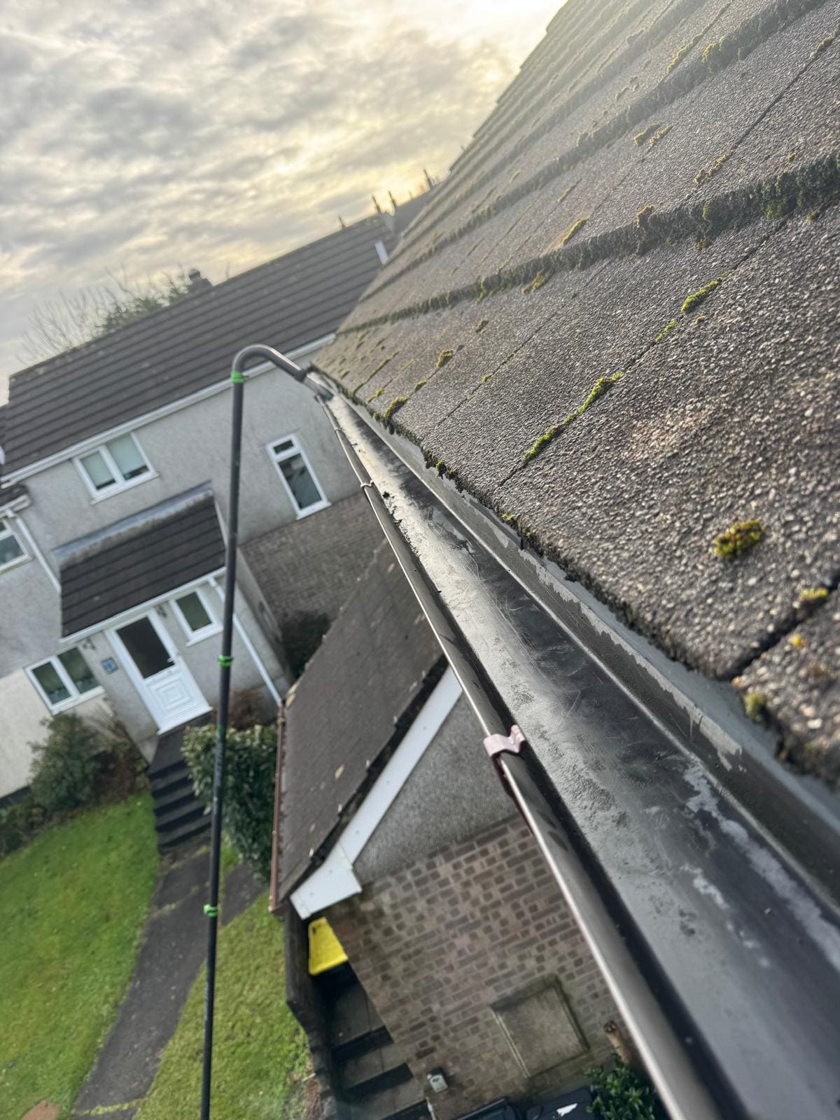 Residential gutters cleared and flowing freely after cleaning
