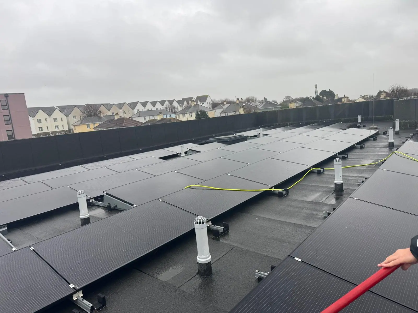 Solar panels on flat roof cleaned using deionised water system in Plymouth