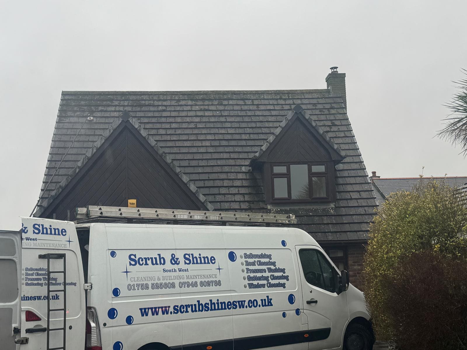 Company van at slate roof cleaning job in Devon
